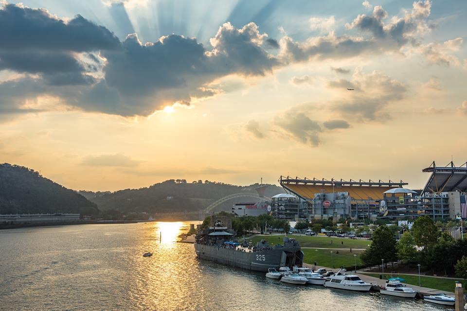 A few rays of sunshine sneak through the clouds over the warship on our rivers. -- DAVE DiCELLO