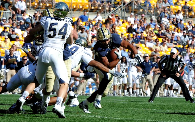 James Conner plows into Akron front seven for some of his 96 yards Saturday at Heinz Field. -- PETE MADIA / PITT ATHLETICS