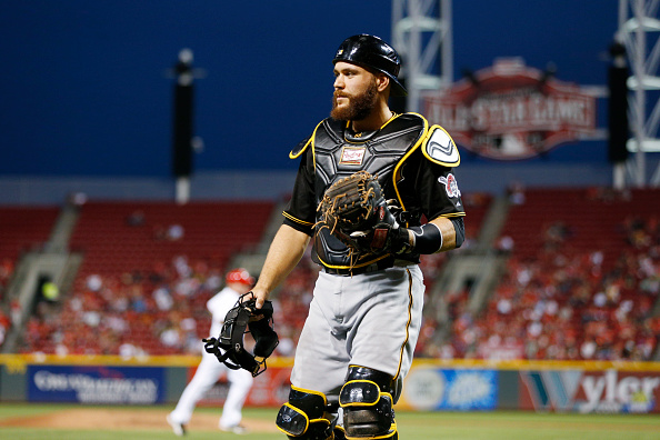 Russell Martin takes off his mask during the Pirates' last road trip of 2014 to Cincinnati. -- GETTY IMAGES